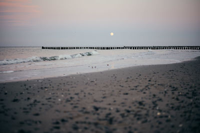 Scenic view of beach against sky during sunset