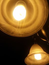 Low angle view of illuminated light bulb