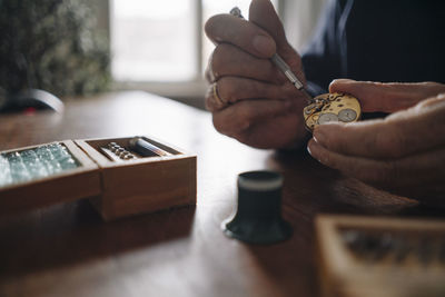 Close-up of senior man repairing a watch