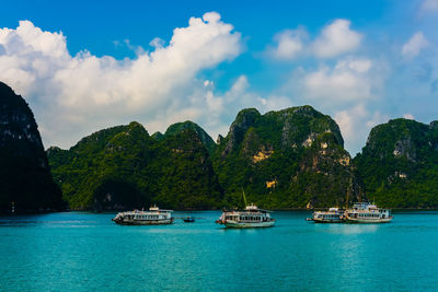 Boats moored on sea against sky