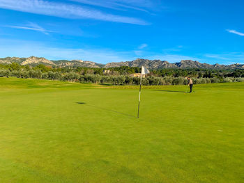 Scenic view of golf course against sky