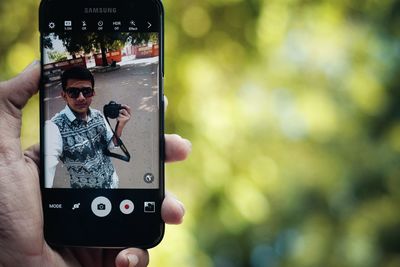 Close-up of man using mobile phone
