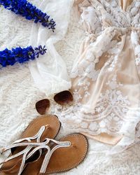 Sandals and sunglasses on wedding dress