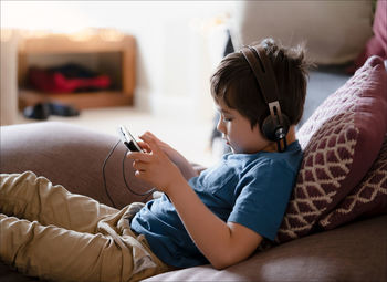 Side view of boy using digital tablet