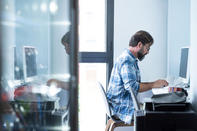 Side view of businessman working at office