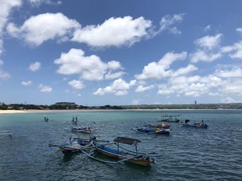 Boats moored in sea against sky