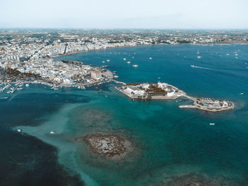 High angle view of sea and city