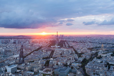 High angle view of city against cloudy sky during sunset