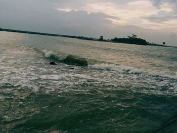 Scenic view of sea against cloudy sky