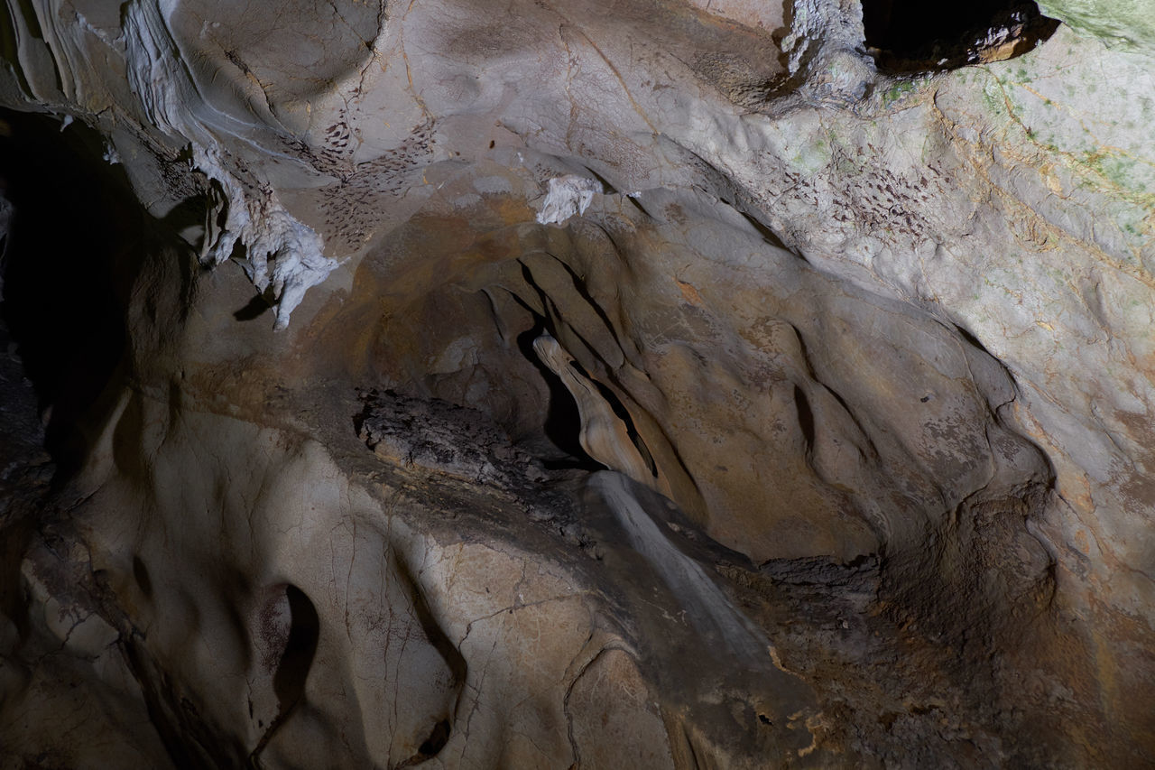LOW ANGLE VIEW OF ROCK FORMATIONS AT CAVE