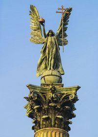 Low angle view of statue of liberty against clear sky