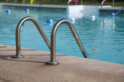 Metal railing by swimming pool