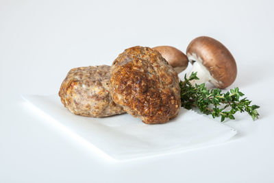 Close-up of burger against white background