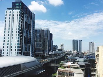 Modern buildings in city against sky