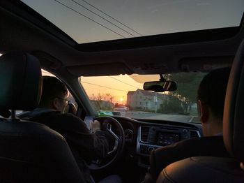 Rear view of man sitting in car