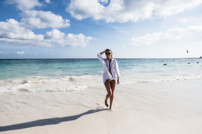 Full length of young woman on beach