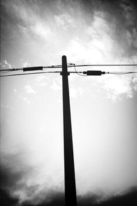 Low angle view of power lines against sky