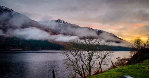 Scenic view of lake and mountains against sky