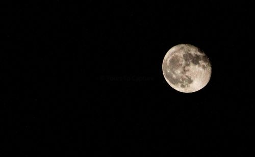 Low angle view of moon against black sky