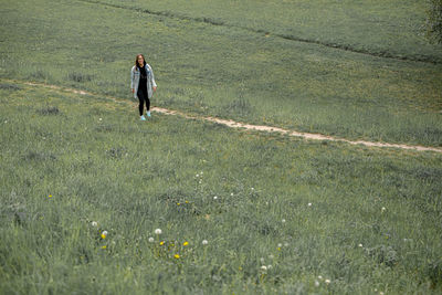 Full length of man walking on field