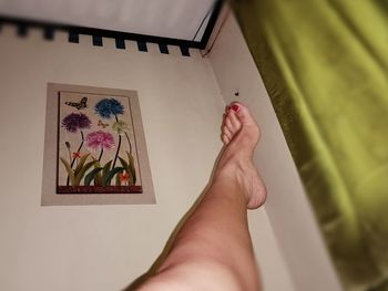 Low section of woman against white wall