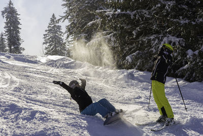 People skiing on land during winter