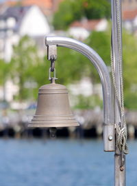 Close-up of water pipe hanging from metal in yard