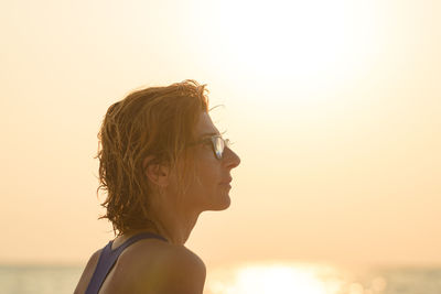 Portrait of woman looking at sunset