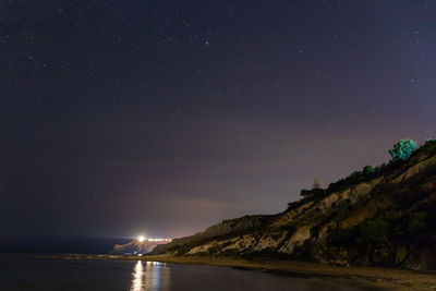 Scenic view of sea against sky at night