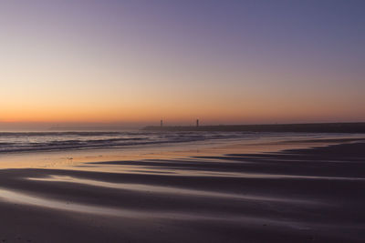 Scenic view of sea against clear sky during sunset