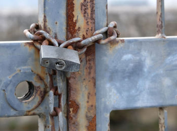 Metal padlock on an old rusty gate