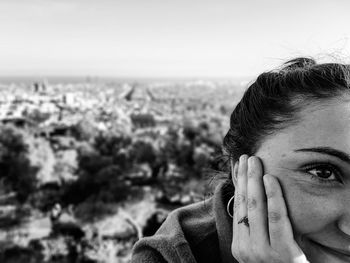 Close-up of young woman against the sky