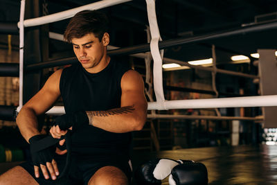 Man preparing for boxing training at health club