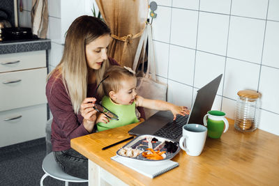 Working mother work remotely. remote work from home. young mother with toddler 