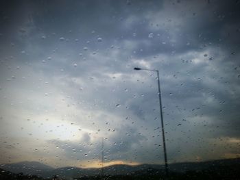 Low angle view of raindrops on window