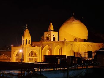 Low angle view of illuminated building against sky at night