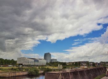 Buildings against cloudy sky