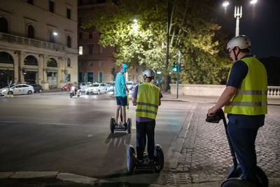 Rear view of people on road at night