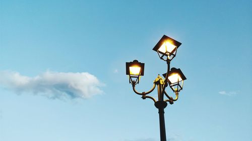 Low angle view of street light against blue sky