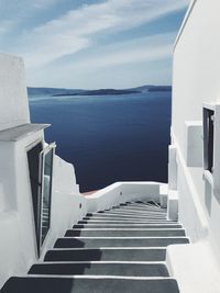 Staircase by sea against sky