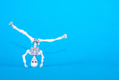 Tilt image of telephone pole against blue background