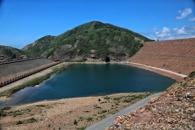 Scenic view of mountains against blue sky