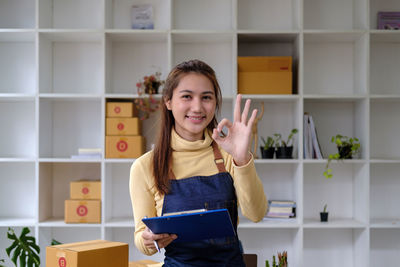 Portrait of young woman standing in library