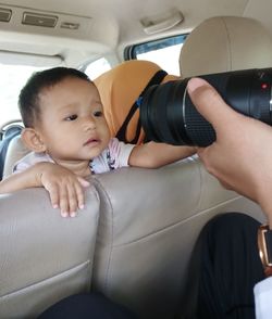 Portrait of cute boy sitting in bus