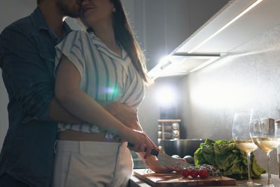 Midsection of woman holding food at home