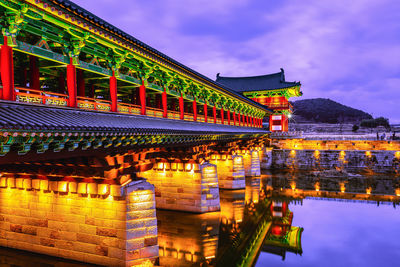 Illuminated bridge against sky at night