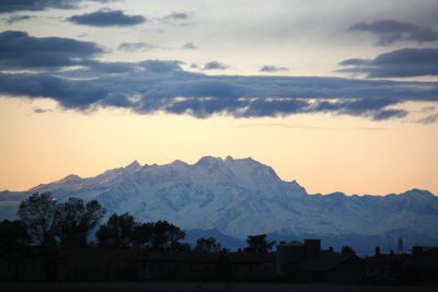 Scenic view of silhouette mountains against sky at sunset