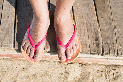 Low section of woman standing on ground