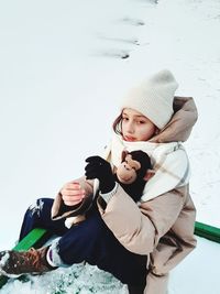 Low angle view of boy standing on snow