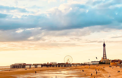 View of amusement park against cloudy sky